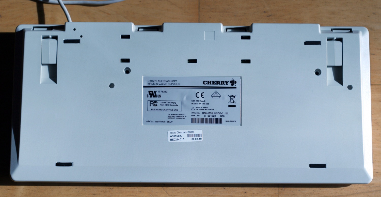 The clean board (bottom) with the keycaps back on. Protip: Do not even think about getting near to the silver Cherry sticker with anything in relation to petrol. You will probably touch the sticker and immediately dissolve/etch the writing and spread it on the whole case, which you then have to rub off again... (I, for one, touched the "CHERRY" part of the Cherry logo and then "decorated" the case above it, which I managed to get almost completely clean beforehand. Luckily, I got it off again, and the logo wasn't really damaged (it's not even visible on the picture), but: Attention is highly advised! (Oh, and the rubber feet are a "no-go area" as well. I think these are even allergic to alcohol (at least ethanol).)